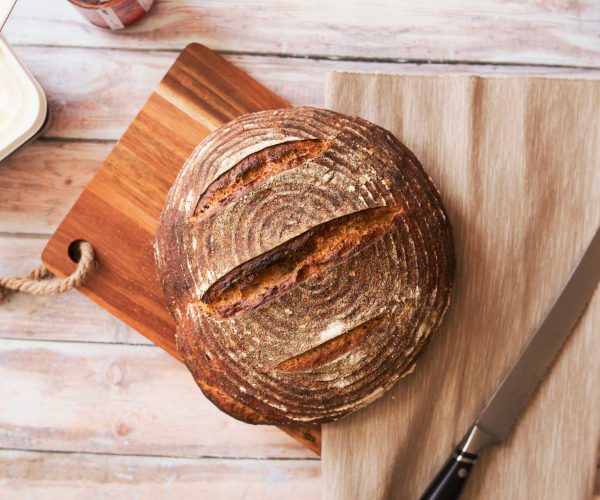 Top view photo of fresh baked bread on painted brown wooden table